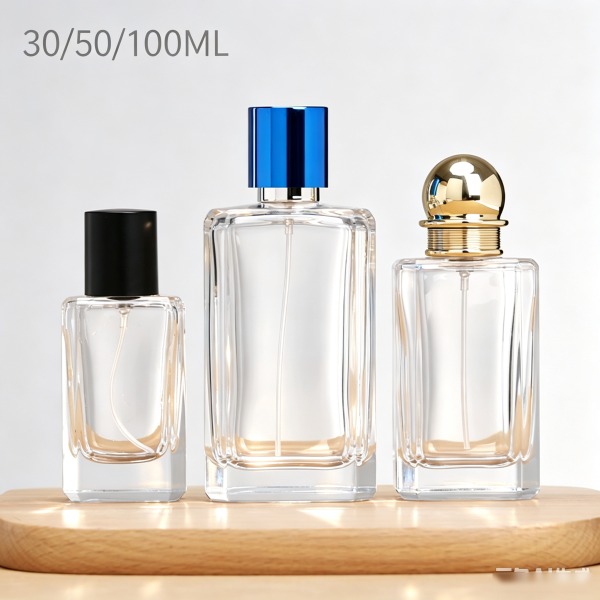 <bdi>45 ml</bdi> cylindrical amber glass perfume bottle atomizer bottle مع decorative cap — wholesale glass packaging from Eaglebottle China factory